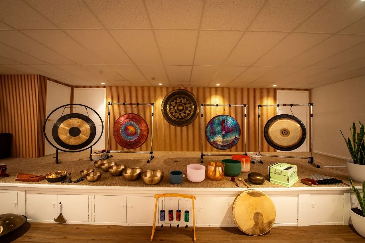 Gongs, singing bowls and other instruments arranged on the studio stage